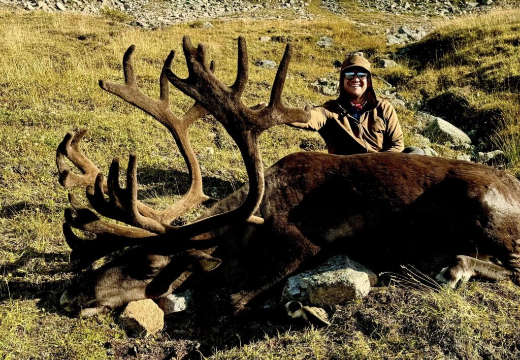 A hunter with a caribou taken with a Rachel Precision rifle