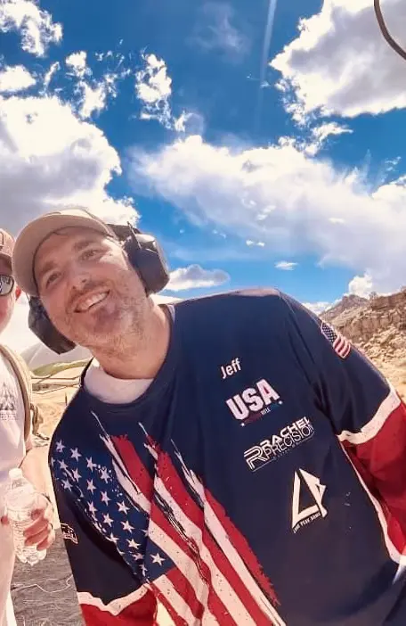 Jeff Guerry smiling in a Team USA jersey with a Rachel Precision logo