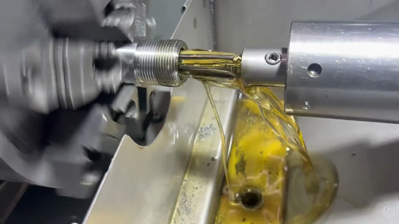 A barrel being chambered on Randy Rachel's lathe, with cutting oil flowing through the reamer